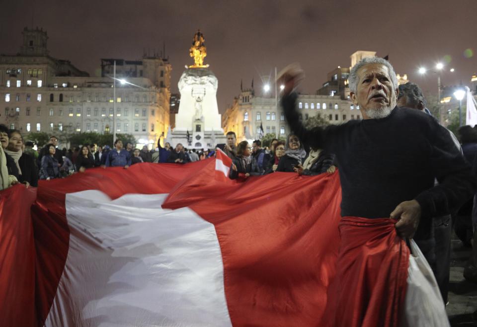 Demonstrators protest against congress, at San Martin Plaza in Lima, Peru, Thursday, Sept. 26, 2019. Congressmen in Peru rejected President Martin Vizcarra's proposal to push forward elections to choose his successor.(AP Photo/Martin Mejia)