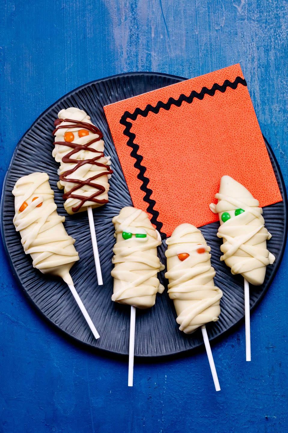 <p>These adorably spooky banana mummies will be the hit of any Halloween party treat table. (Your kids won't even notice they're eating fruit!)</p><p><a href="https://www.womansday.com/food-recipes/food-drinks/recipes/a12930/banana-mummies-recipe-wdy1014/" rel="nofollow noopener" target="_blank" data-ylk="slk:Get the Banana Mummy Pops recipe.;elm:context_link;itc:0;sec:content-canvas" class="link "><strong><em>Get the Banana Mummy Pops recipe. </em></strong> </a> </p>