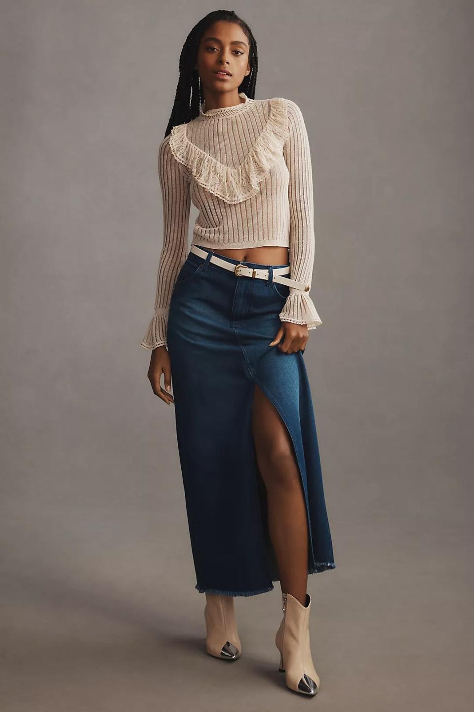 model wearing denim maxi skirt with white long sleeve top