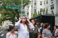 <p>People take a break from work to witness the solar eclipse on Broadway in New York City on Aug. 21, 2017. (Gordon Donovan/Yahoo News) </p>