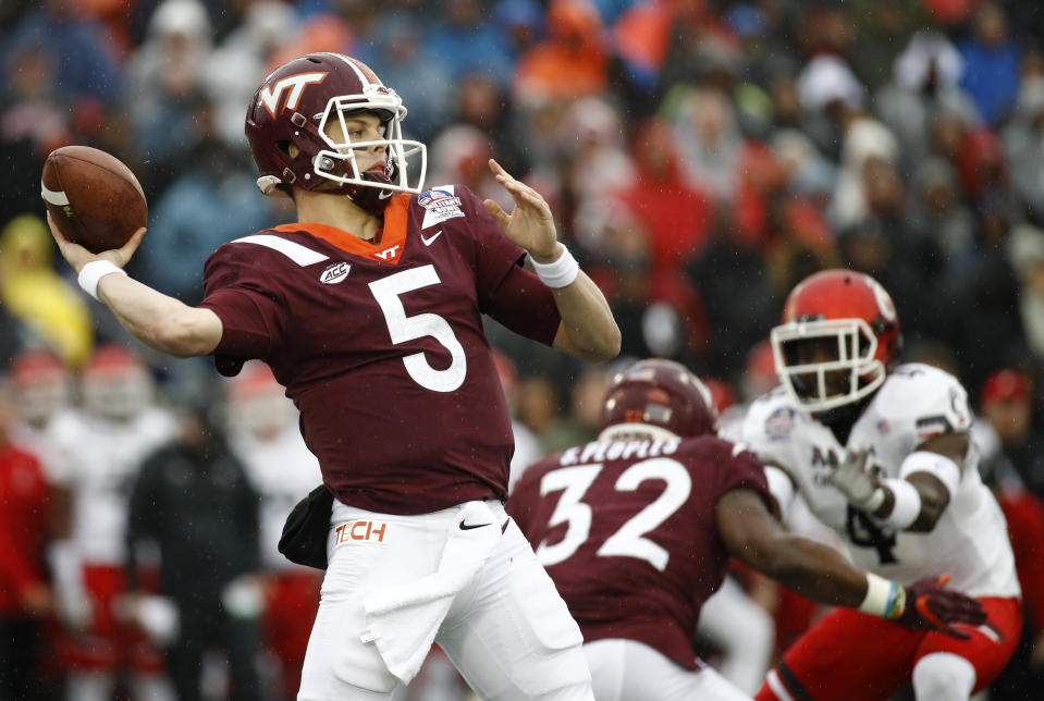 Virginia Tech quarterback Ryan Willis (5) throws a pass in the first half of the Military Bowl NCAA college football game against Cincinnati, Monday, Dec. 31, 2018, in Annapolis, Md. (AP Photo/Patrick Semansky)
