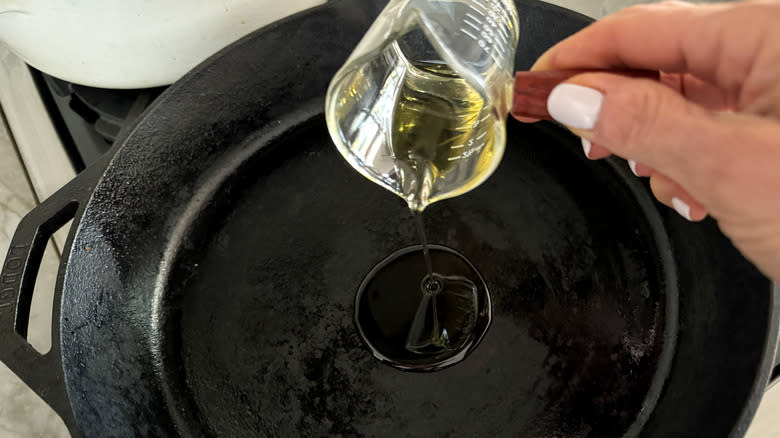 adding oil to a pan