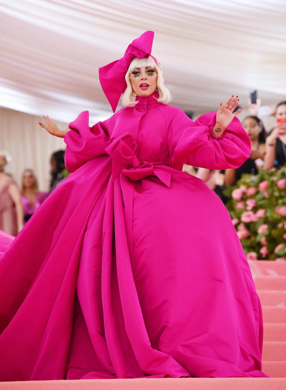 lady gaga attends the met gala in 2019 wearing pink ballgown and headpiece