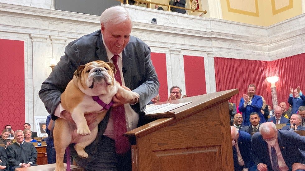 West Virginia Gov. Jim Justice holds Babydog, his English Bulldog, during his State of the State address