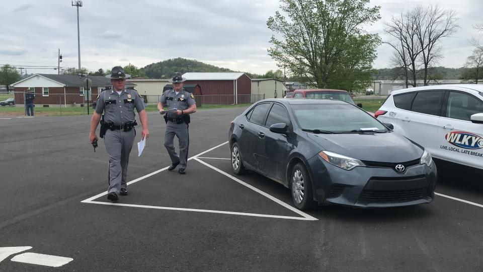 Kentucky State Troopers take down license plate numbers of people attending an in-person Easter service at Maryville Baptist Church in Hillview, Kentucky.