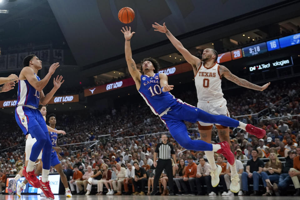 Kansas forward Jalen Wilson (10) shoots past Texas forward Timmy Allen (0) during the first half of an NCAA college basketball game in Austin, Texas, Saturday, March 4, 2023. (AP Photo/Eric Gay)