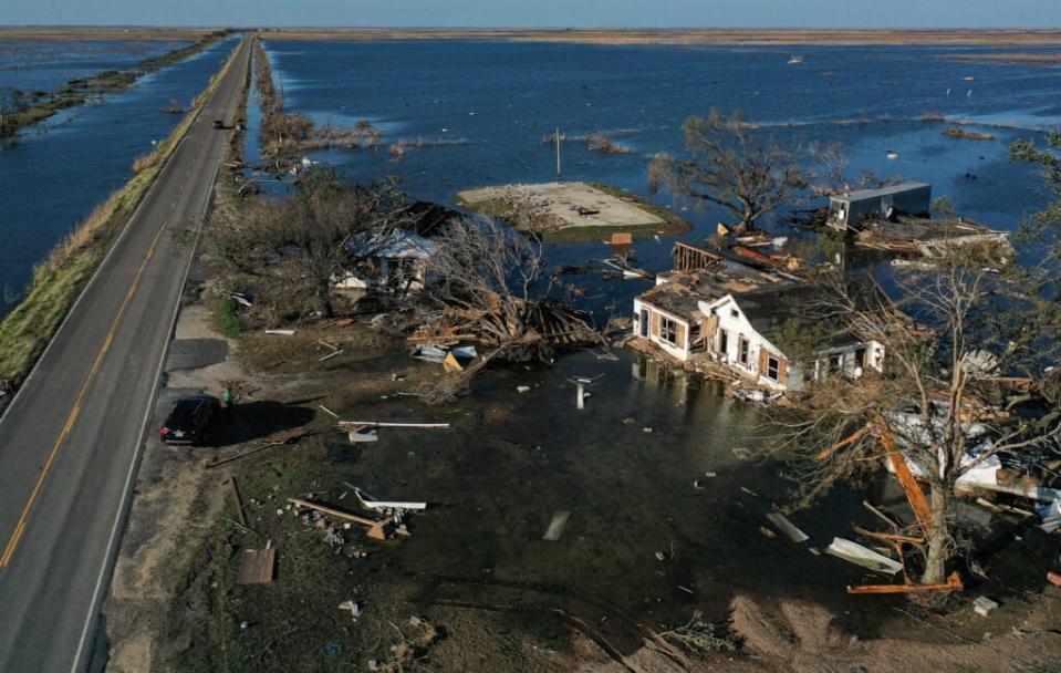 An aerial view of flood waters from Hurricane Delta surrounding structures destroyed by Hurricane Laura (R) on October 10, 2020 in Creole, Louisiana. (Photo by Mario Tama/Getty Images)