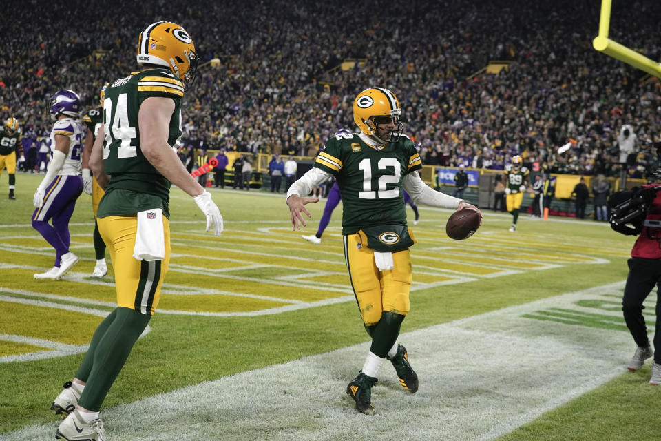 Green Bay Packers quarterback Aaron Rodgers (12) celebrates after scoring on a 2-yard touchdown run during the second half of an NFL football game against the Minnesota Vikings, Sunday, Jan. 1, 2023, in Green Bay, Wis. (AP Photo/Morry Gash)