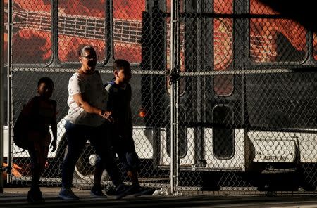 Children are escorted to the Cayuga Center, which provides foster care and other services to immigrant children separated from their families, in New York City, U.S., July 10, 2018. REUTERS/Brendan McDermid