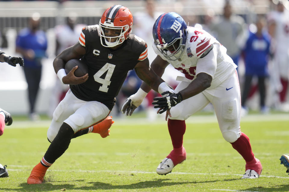 Cleveland Browns quarterback Deshaun Watson (4) runs against New York Giants defensive tackle Elijah Chatman during the second half of an NFL football game, Sunday, Sept. 22, 2024, in Cleveland. (AP Photo/Sue Ogrocki)