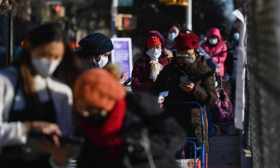 People stand in line at a food distribution event ahead of the Thanksgiving holiday on Friday in Brooklyn, New York.