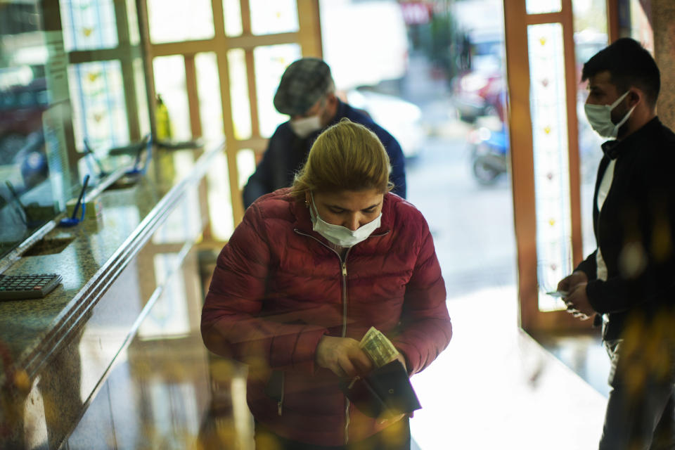 A woman holdsUS dollars notes after exchanging Turkish liras in a money exchange office in Istanbul, Turkey, Thursday, Nov. 11, 2021. Many Turkish consumers are faced with increased hardship as prices of food and other goods have soared in recent years. The yearly consumer price index increased by 19.9% in October, up from 19.58% in September, according to official data by the Turkish Statistical Institute released on Nov. 3. (AP Photo/Francisco Seco)