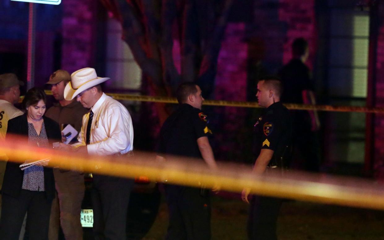 Law enforcement officers and investigators gather outside the scene of a shooting in Plano, Texas - AP