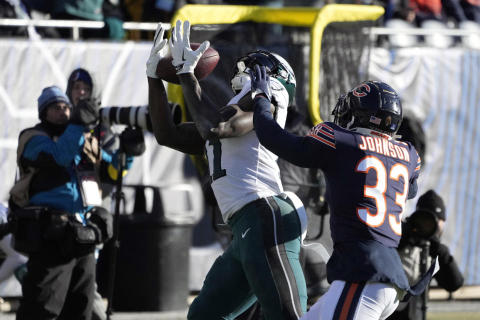 Philadelphia Eagles' A.J. Brown (11) catches a pass against Chicago Bears' Jaylon Johnson (33) during the second half of an NFL football game, Sunday, Dec. 18, 2022, in Chicago. (AP Photo/Charles Rex Arbogast)