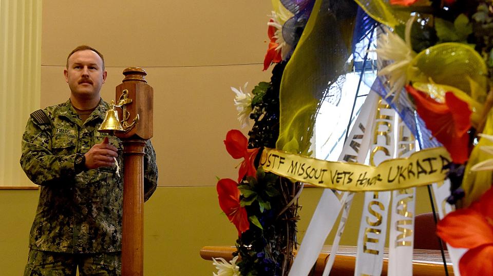 U.S. Navy Machinist's Mate Auxiliary First Class Kenneth Fields performs the Navy Bell Toll and Final Roll Call for fallen veterans and Ukraine Baptist Seminary students and staff and all Ukrainian soldiers and citizens in harm’s way on Thursday during the U.S. Exercise Tiger Foundation wreath-laying ceremony at the Boone County Government Center.