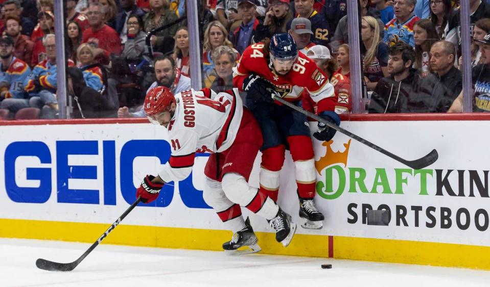 Florida Panthers left wing Ryan Lomberg (94) and Carolina Hurricanes defenseman Shayne Gostisbehere (41) fight for possession of the puck in the first period of Game 3 of the NHL Stanley Cup Eastern Conference finals series at the FLA Live Arena on Monday, May 22, 2023 in Sunrise, Fla.