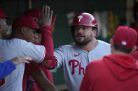 Philadelphia Phillies' Kyle Schwarber, center, celebrates with teammates in the dugout after hitting a solo home run during the first inning of a baseball game against the Oakland Athletics in Oakland, Calif., Friday, June 16, 2023. (AP Photo/Godofredo A. Vásquez)