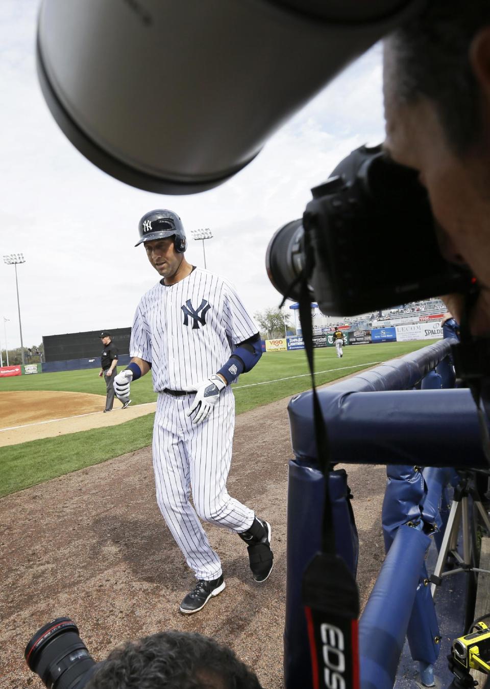 New York Yankees shortstop Derek Jeter walks back to the dugout after grounding out during the fourth inning of an exhibition baseball game against the Pittsburgh Pirates Thursday, Feb. 27, 2014, in Tampa, Fla. (AP Photo/Charlie Neibergall)