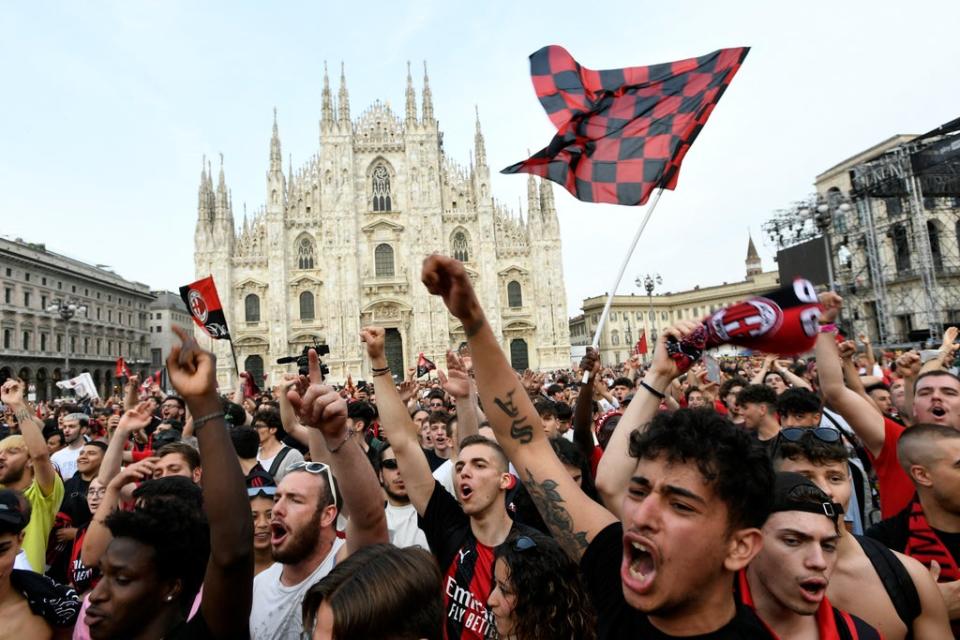 AC Milan fans celebrate their title triumph in the city centre (REUTERS)