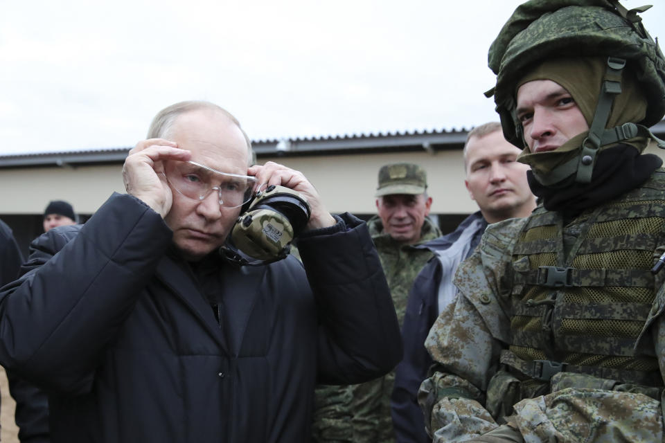 FILE - Russian President Vladimir Putin puts on protective glasses as he visits a military training center of the Western Military District for mobilized reservists in Ryazan Region, Russia, Thursday, Oct. 20, 2022. (Mikhail Klimentyev, Sputnik, Kremlin Pool Photo via AP, File)