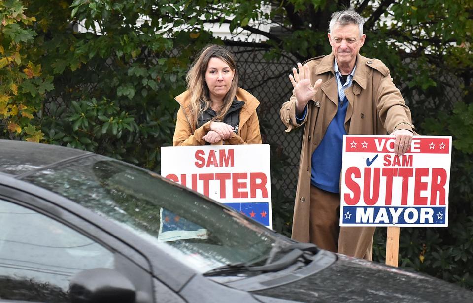Lisa Rowell and mayoral candidate Sam Sutter campaign at the entrance to the polling site at the Alfred S. Letourneau Elementary School in Fall River on Tuesday Nov. 7, 2023.