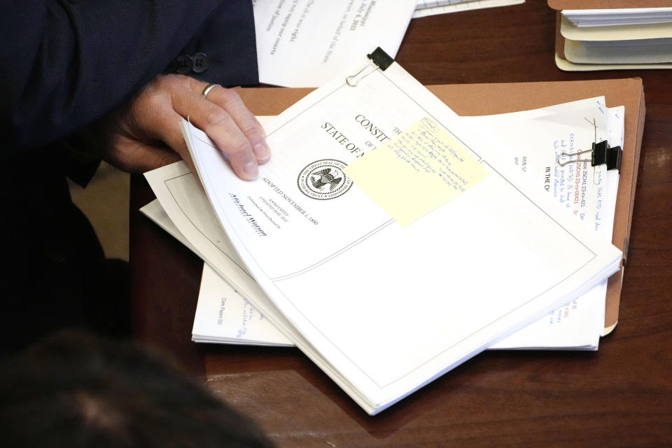 Solicitor General Scott G. Stewart reviews a printout of the Mississippi Constitution during arguments over the constitutionality of a Mississippi law that would authorize some judges who would be appointed in a state where most judges are elected, Thursday, July 6, 2023, in Jackson, Miss. (AP Photo/Rogelio V. Solis)