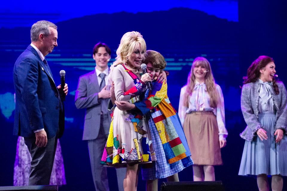 Dolly Parton hugs a cast member from the “From the Heart- The Life and Music of Dolly Parton," a new Dollywood show that will run through the Flower and Food Festival this spring.