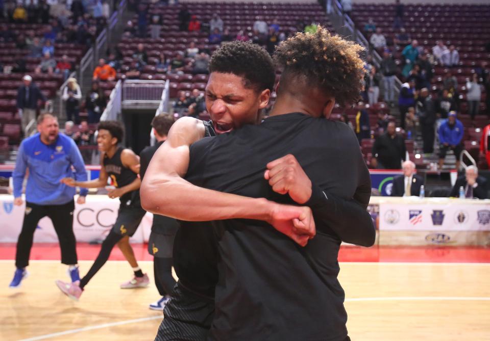 Lincoln Park's Meleek Thomas hugs Aaron Smith after the Leopards defeated Neumann-Goretti 62-58 in the PIAA 4A Championship game Thursday night at the Giant Center in Hershey, PA.