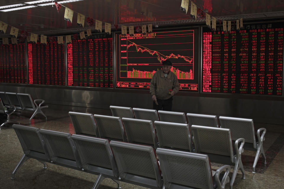 A man prepares to leave a quiet brokerage house in Beijing, Wednesday, Jan. 9, 2019. Shares extended gains in Asia on hopes for progress in resolving the tariffs battle between the U.S. and China as talks appeared to have been extended in Beijing. (AP Photo/Andy Wong)