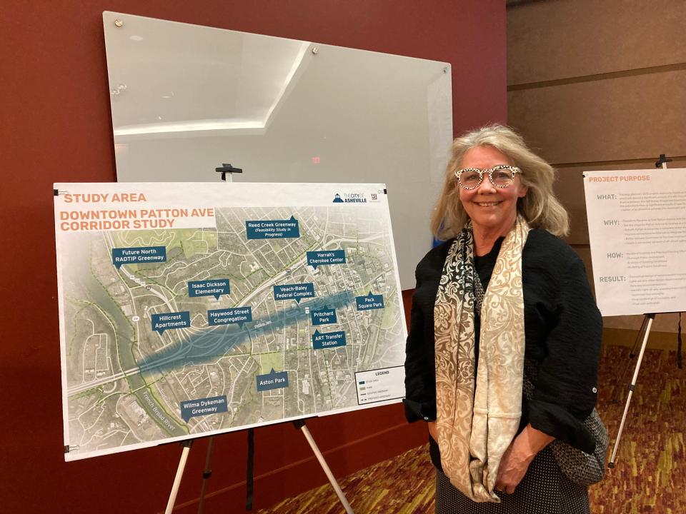 Susan Loftis stands in front of a graphic demonstrating the city's Patton Avenue Corridor Feasibility study area at an open house on Nov. 29, 2023.