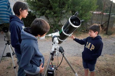 FILE PHOTO: Ricardo Barriga, 10, speaks and teaches astronomy to younger in hopes of raising money for his own astronaut suit, Pirque, Chile January 16, 2019. REUTERS/Rodrigo Garrido