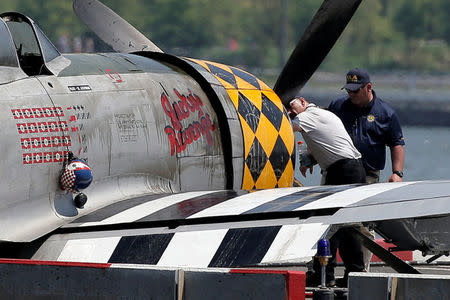 FAA investigators look over the wreckage of a vintage P-47 Thunderbolt airplane that crashed in the Hudson River in New York City, New York, U.S. May 28, 2016. REUTERS/Brendan McDermid