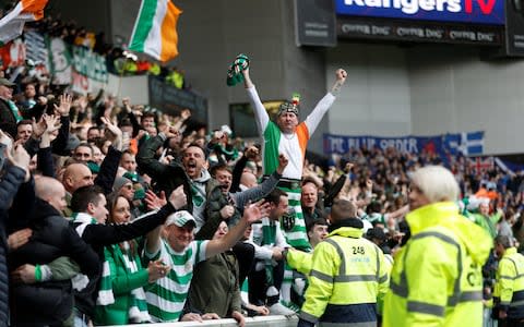 Celtic fans looking triumphant at Ibrox - Credit: Russell Cheyne/Reuters