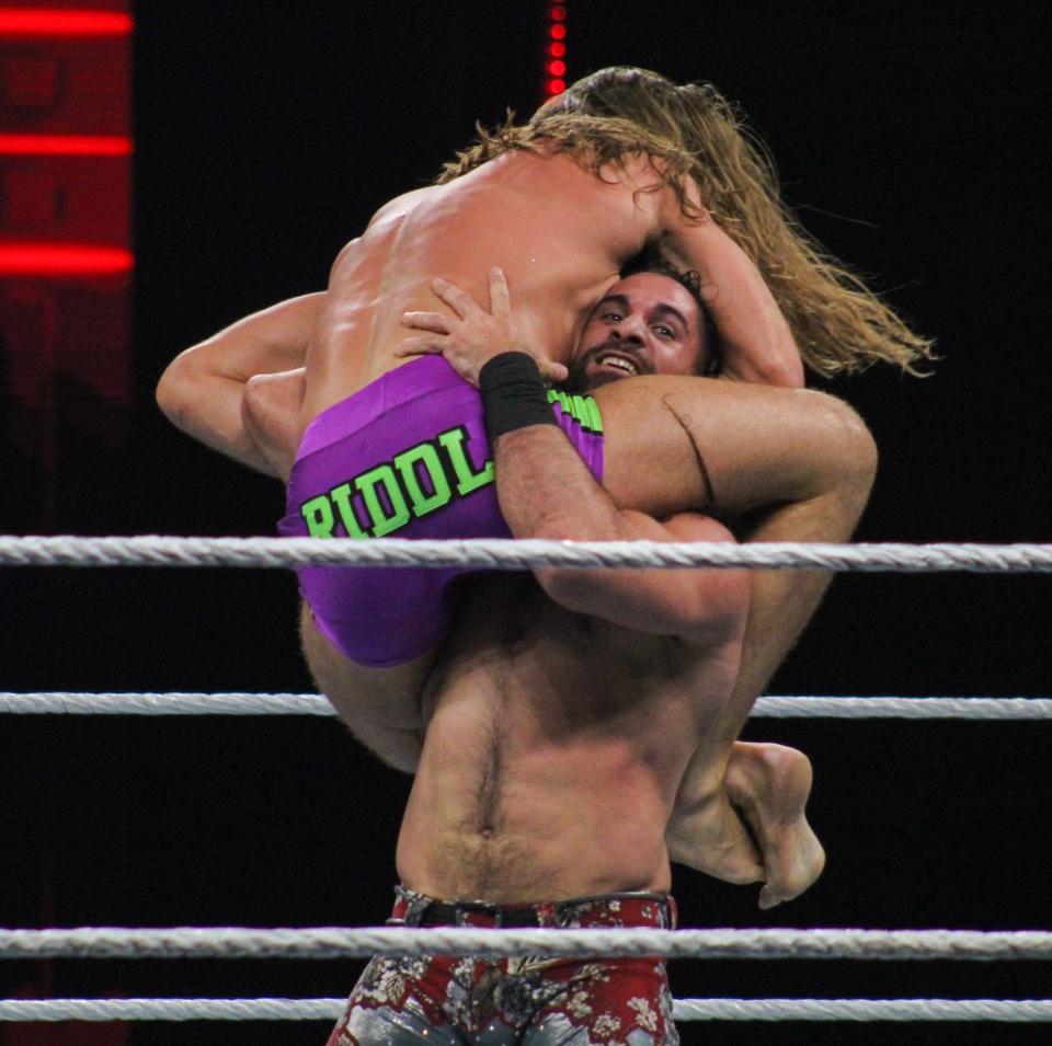 Seth Rollins lifts Riddle onto his shoulder during the WWE Saturday Night's Main Event house show in the Amarillo Civic Center on Saturday, June 25, 2022.