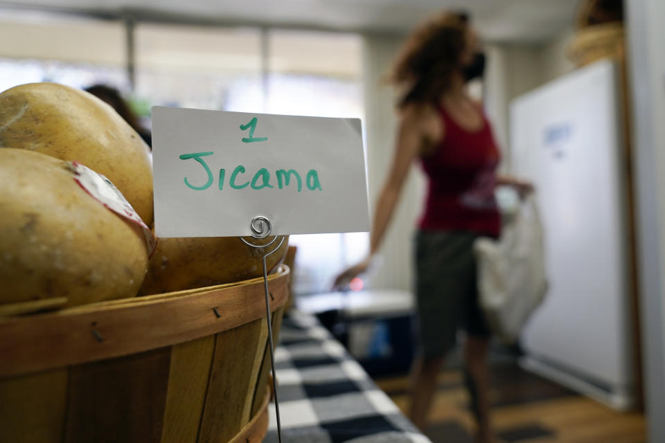 Ariana looks for items at Porchlight Community Service food pantry Thursday, May 6, 2021, in San Diego. For millions of Americans with food allergies or intolerances, the pandemic has created a particular crisis: Most food banks and government programs offer limited options. (AP Photo/Gregory Bull)