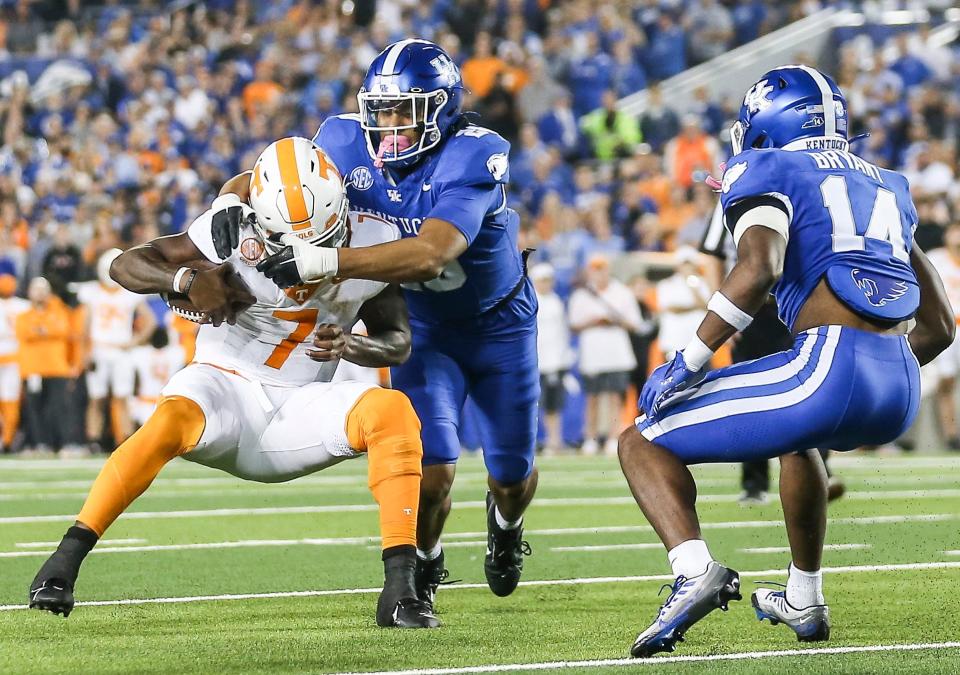 Kentucky linebacker Keaten Wade (20) sacks Tennessee quarterback Joe Milton III in the fourth quarter of a game Oct. 28 in Lexington. After two seasons with the Wildcats, Wade entered the transfer portal Dec. 4.
