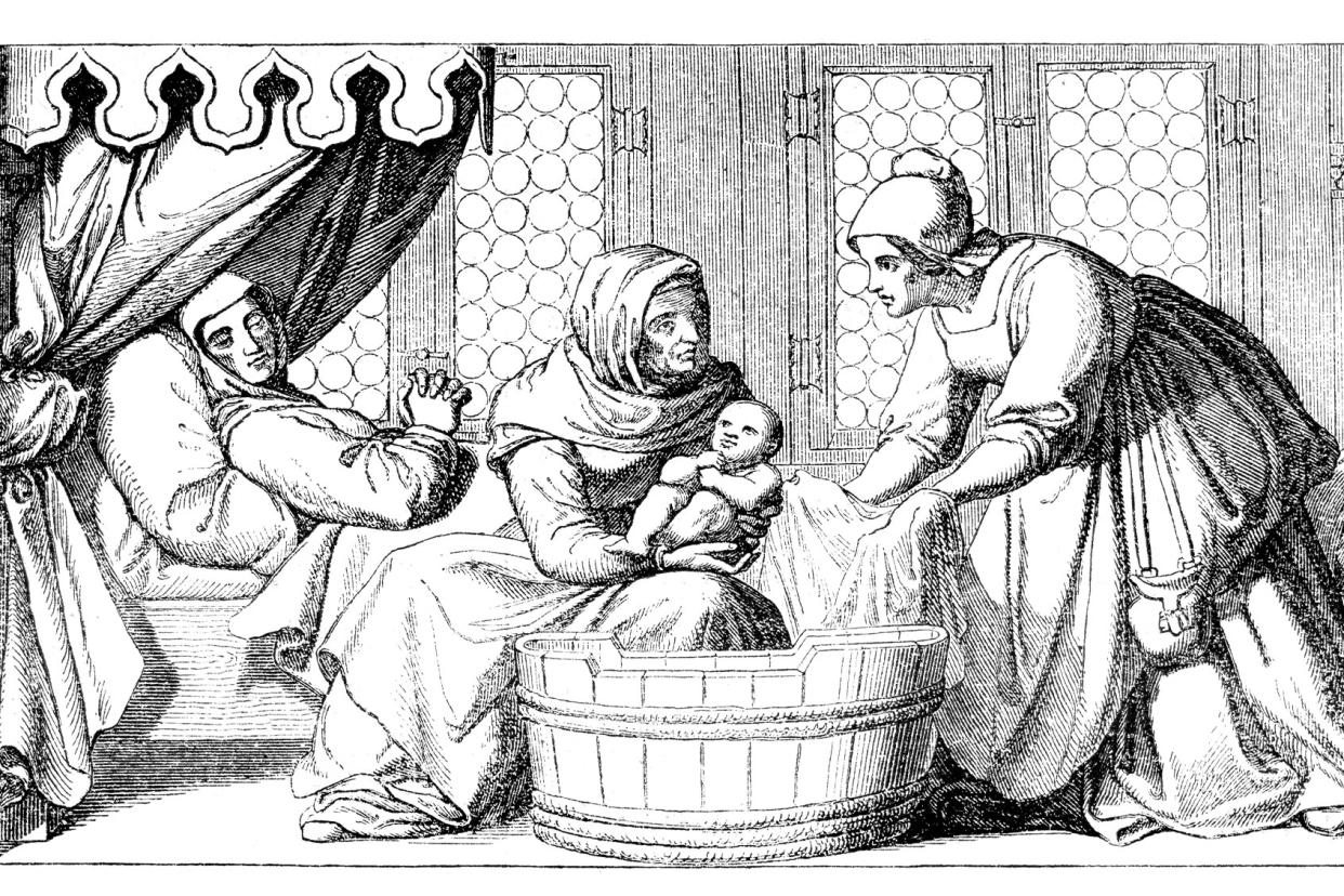 medieval engraving of midwife bathing newborn Getty Images/Grafissimo