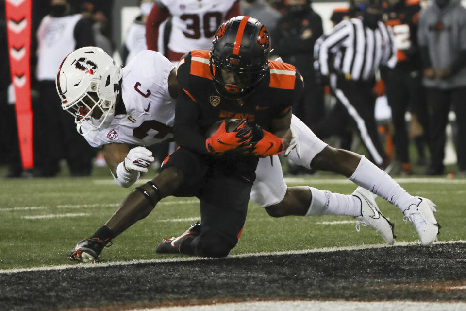 Oregon State wide receiver Tyjon Lindsey (1) runs past Stanford free safety Malik Antoine (3) to score a touchdown during the first half of an NCAA college football game in Corvallis, Ore., Saturday, Dec. 12, 2020. (AP Photo/Amanda Loman)