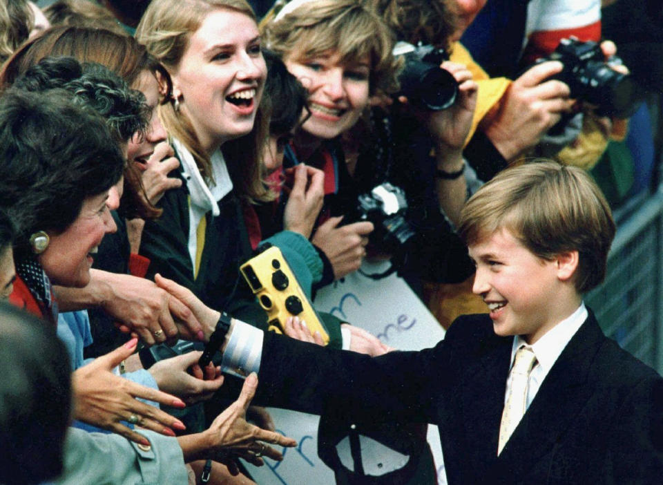 FILE - Britain's Prince William shakes hands with admirers during a stop at St. James Cathedral in Toronto, Canada, in this Oct. 27, 1991 file photo. The world watched as Prince William grew from a towheaded schoolboy to a dashing air-sea rescue pilot to a father of three. But as he turns 40 on Tuesday, June 21, 2022, William is making the biggest change yet: assuming an increasingly central role in the royal family as he prepares for his eventual accession to the throne. (AP Photo/Hans Deryk, File)