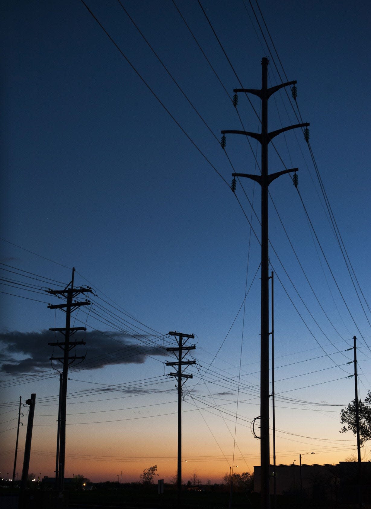 Towers supporting 69-kilovolt transmission lines are silhouetted against the sky in Missouri. The Power from the Prairie project would connect the two U.S. grids (which both have a footprint in South Dakota) with a 4,000-megawatt electric transmission line.