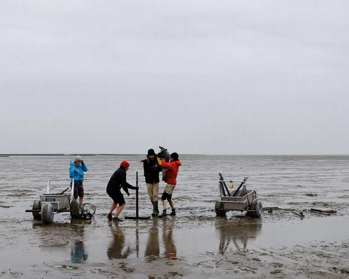 Researchers extract sediment to analyze the buried settlement’s remains.