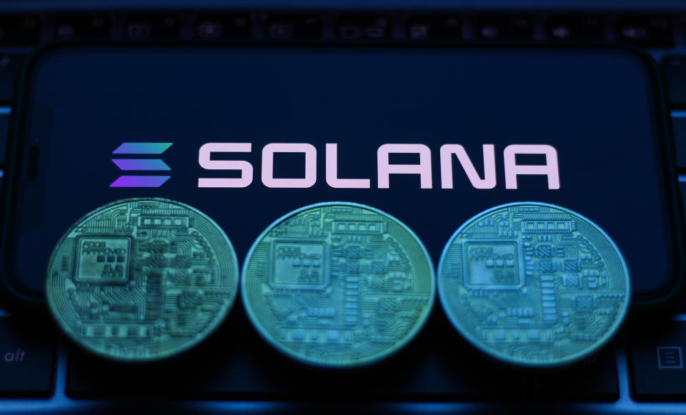 Solana logo and coins displayed on a phone screen.