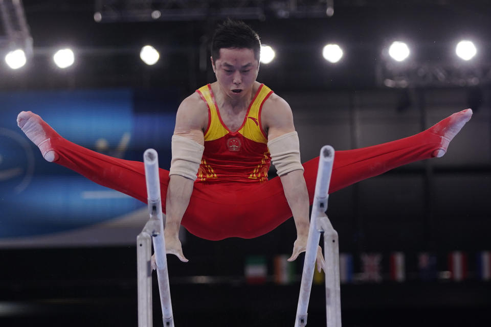 China's You Hao performs on the parallel bars during the men's artistic gymnastic qualifications at the 2020 Summer Olympics, Saturday, July 24, 2021, in Tokyo. (AP Photo/Gregory Bull)