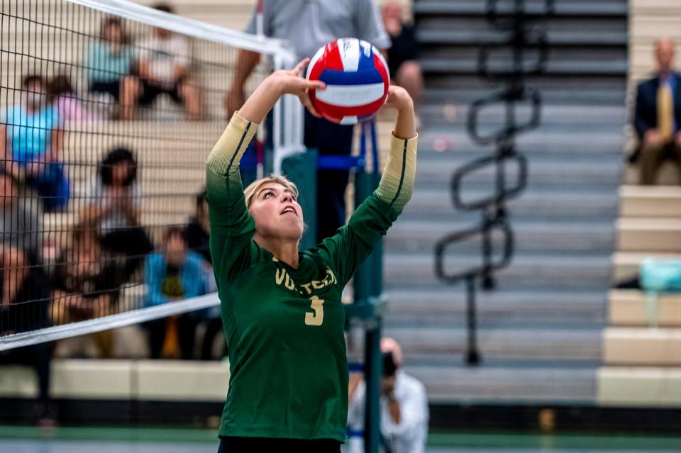 GNB Voc-Tech's Elle McCormick sets the ball for an outside hitter.