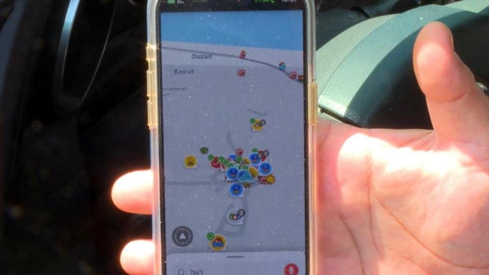 A Hand Holding A Mobile Phone Showing A Navigation App