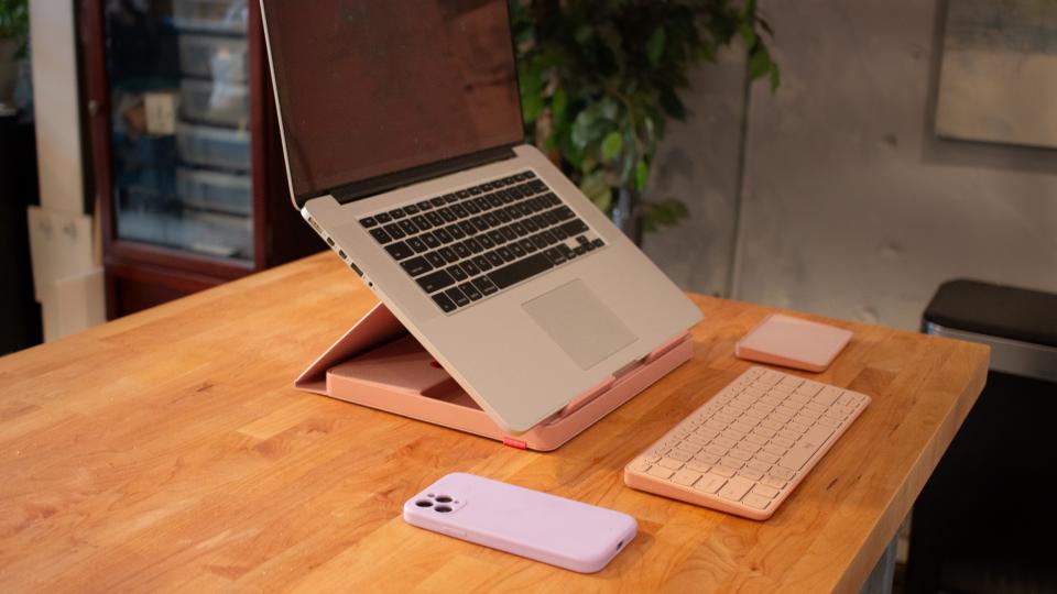 laptop placed on pink Logitech Casa pop-up desk