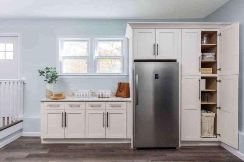 Build in cabinets with refrigerator, dark wood floors