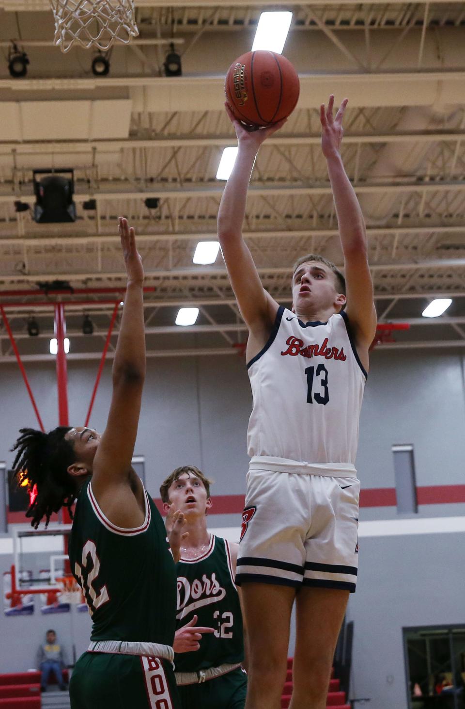 Ballard forward Nolan Cogdill (13) takes a shot over Boone's forward Jinub Yol (12) during the second quarter of the Bombers' 56-46 loss to the Toreadors at Ballard High School Thursday, Jan. 20. 2023, in Huxley, Iowa.