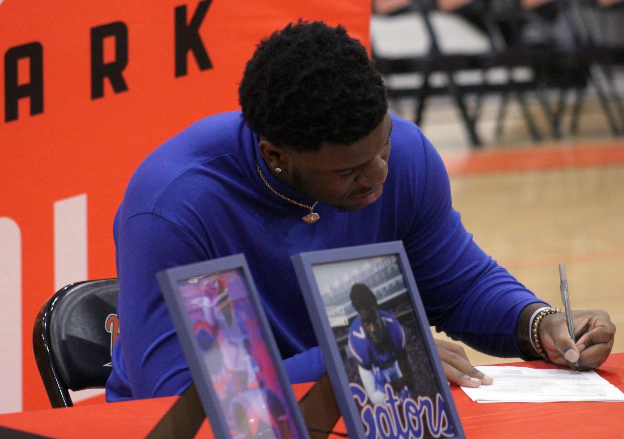 Orange Park offensive lineman Roderick Kearney signs his letter of intent to play college football at the University of Florida on December 21, 2022. [Clayton Freeman/Florida Times-Union]