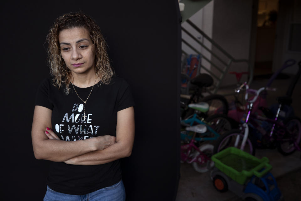 Issis Zavala, of Honduras, poses for a picture Thursday, May 7, 2020, in Carlsbad, Calif. Zavala was detained at the Otay Mesa Detention Center before being released with an ankle bracelet. The early absence of facial coverings, lack of cleaning supplies and mixing symptomatic detainees with others preceded the first big outbreak at U.S. Immigration and Customs Enforcement's 221 detention centers. While the point of origin is unclear, accounts of how the virus spread at the Otay Mesa Detention Center expose shortcomings and inherent difficulties of managing the world's largest immigration detention system during a pandemic. (AP Photo/Gregory Bull)